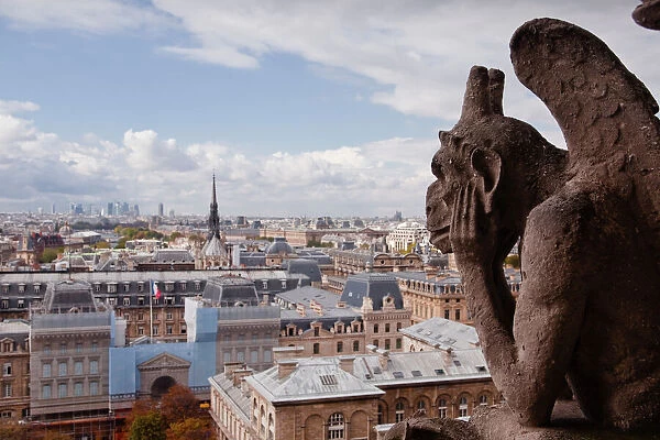 A gargoyle stares out from Notre Dame de Paris cathedral, Paris, France, Europe