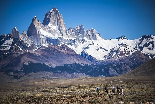 Gauchos riding horses and herding sheep with Mount Fitz Roy behind, UNESCO World Heritage Site