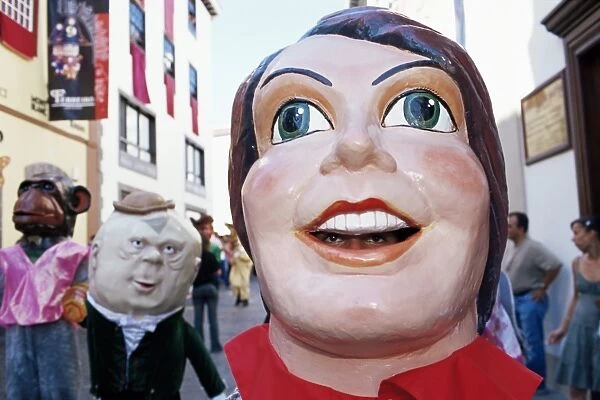 Giant masks on parade during celebration of Descent of Our Lady of Snows fiesta