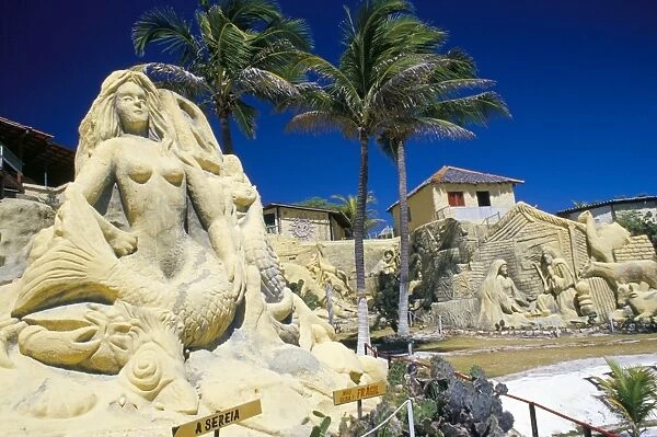 Giant sand sculpture of a mermaid and bungalows on the Ceara coastline