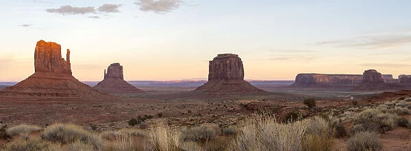 The giant sandstone buttes glowing pink at sunset in Monument Valley Navajo Tribal