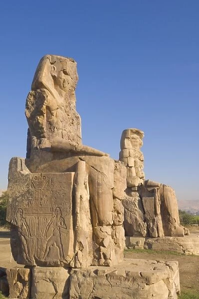 Two giant statues known as the Colossi of Memnon carved to represent the pharaoh Amenhotep III of the dynasty XVIII, West bank of the River Nile, Thebes, UNESCO World Heritage Site, Egypt, North