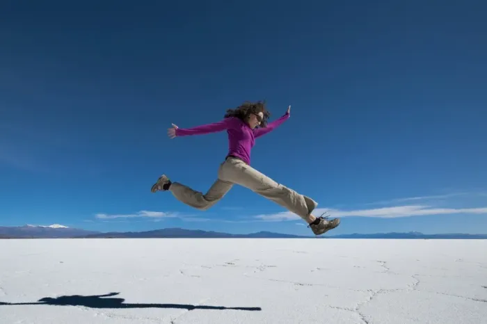 Framed Print : A girl leaps into the air at the Salinas Grandes (salt flats) near Purmamarca, Argentina Framed Print : A girl leaps into the air at the Salinas Grandes (salt flats) near Purmamarca, Argentina