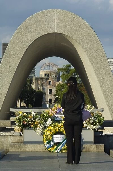 Girl praying at cenotaph