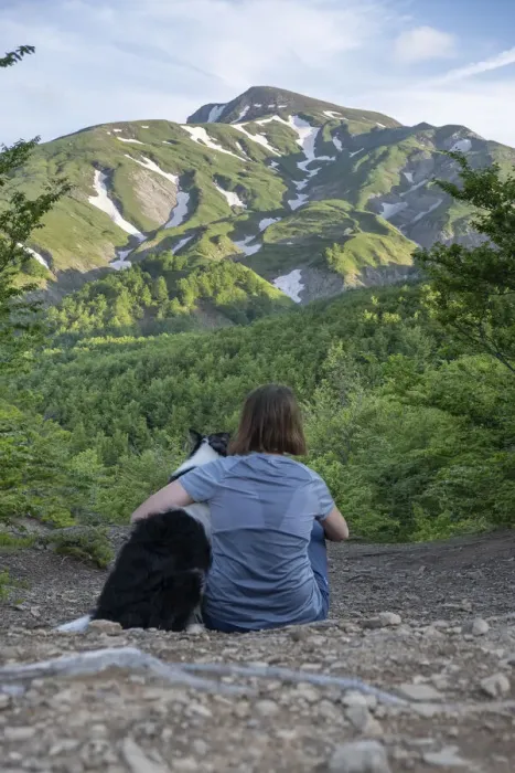 Framed Print : A girl sitting beside and hugging her border collie dog staring at a mountain landscape of Cusna Mountain, Emilia Romagna, Italy, Europe Framed Print : A girl sitting beside and hugging her border collie dog staring at a mountain landscape of Cusna Mountain, Emilia Romagna, Italy, Europe