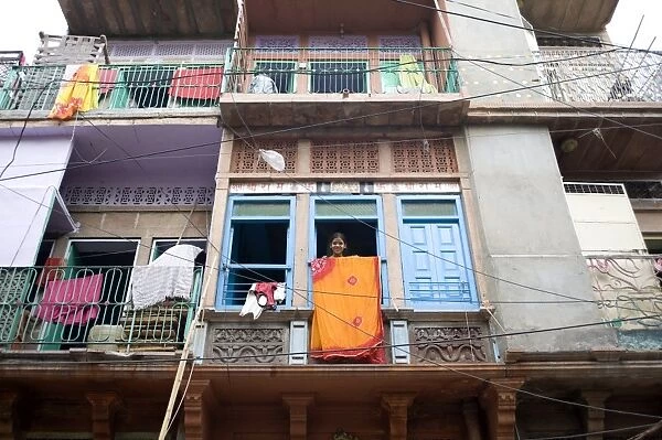 Girl at window with sari drying, Jodhpur, Rajasthan, India, Asia