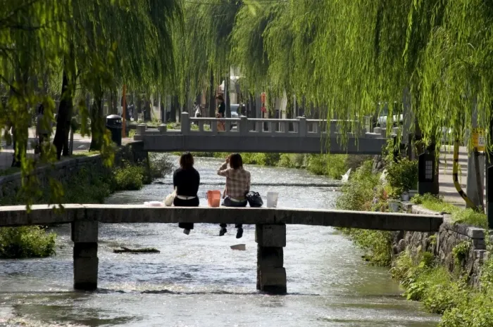 Framed Print : Two girls sitting on bridge Framed Print : Two girls sitting on bridge