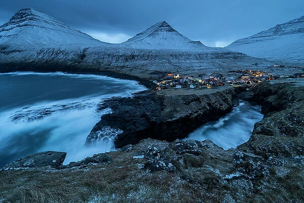Gjogv village and snow covered mountains at dusk, Gjogv, Eysturoy Island, Faroe Islands, Denmark, Europe