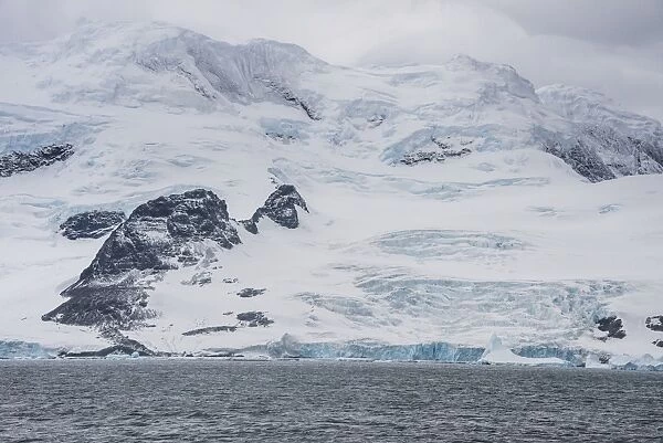 Glacier hanging on the rocks of Coronation Island, South Orkney Islands, Antarctica