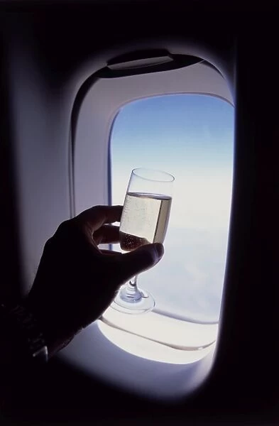 Glass of champagne at 30000 feet and aircraft window