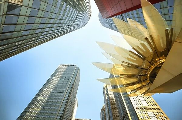 Glass and golden metal Lotus installation in front of HSBC Bank with surrounding