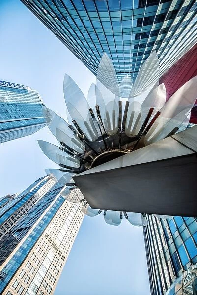 Glass and metal Lotus installation in front of HSBC Bank with surrounding new skyscrapers