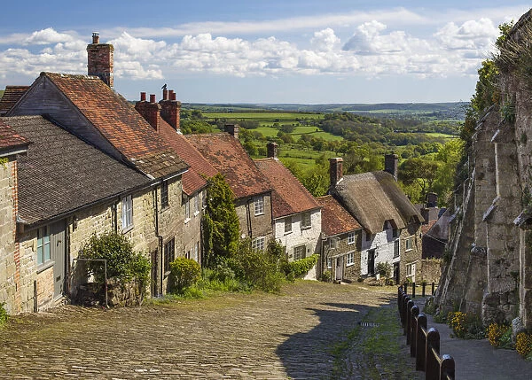 Gold Hill, cobbled lane lined with cottages and views over countryside, Shaftesbury