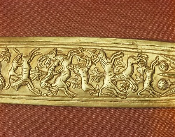 Detail of the gold sheath of one of the kings daggers showing animals in a hunting scene