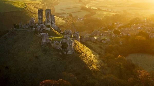 Golden sunrise over the village and castle at Corfe, Dorset, England, United Kingdom