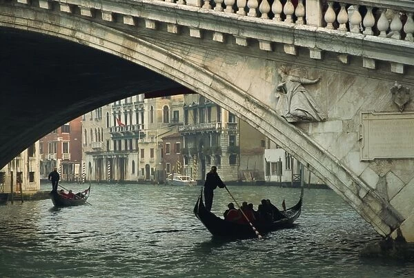 Gondola under the Rialto Bridge on the Grand Canal in Venice