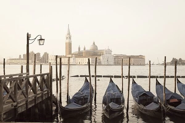 Gondolas moored on the Lagoon, San Giorgio Maggiore beyond, Riva degli Schiavoni, Venice, UNESCO World Heritage Site, Veneto, Italy, Europe