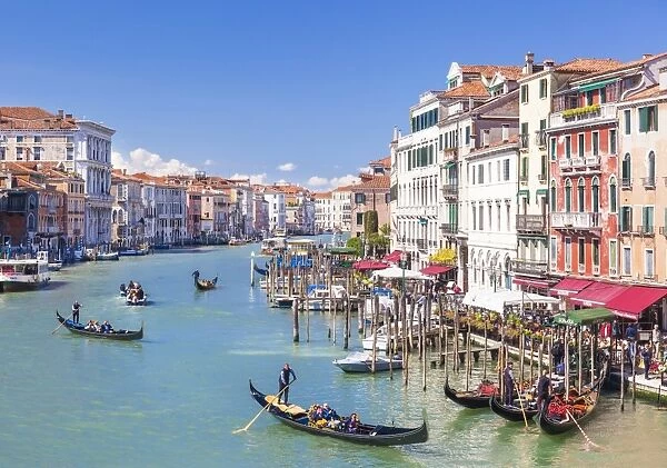 Gondolas, with tourists, on the Grand Canal, next to the Fondementa del Vin, Venice