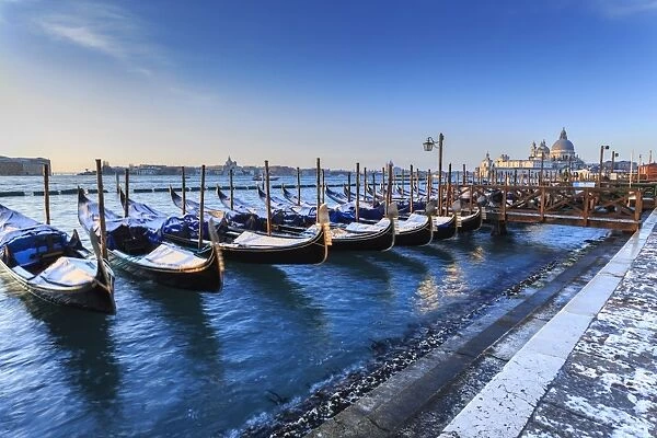 Gondolas with view to Basilica di Santa Maria della Salute after snow, Venice, UNESCO
