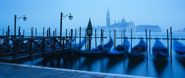 Gondolas on the waterfront of St. Marks Basin at dawn, Venice, UNESCO World Heritage Site
