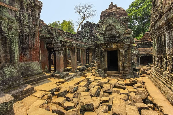 Gopura entrance and weathered carved sandstone walls in the 12th century Preah Khan