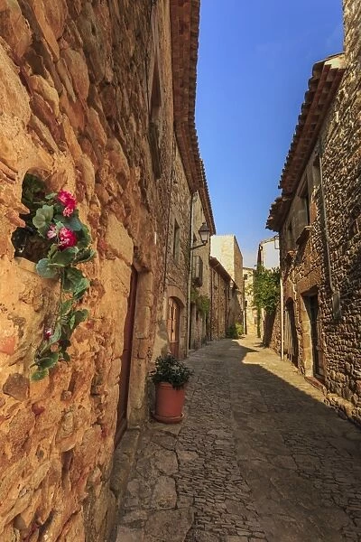 Gorgeous medieval village, cobblestone narrow lane and flowers, Peratallada, Baix Emporda