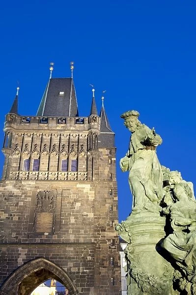 Gothic Old Town Bridge Tower and statue of St. Ivo (Bishop of Chartres) at twilight, Old Town, UNESCO World Heritage Site, Prague, Czech Republic, Europe