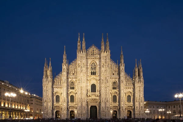 Gothic spires on the facade of the Milan Cathedral in the Piazza del Duomo at dusk, Milan