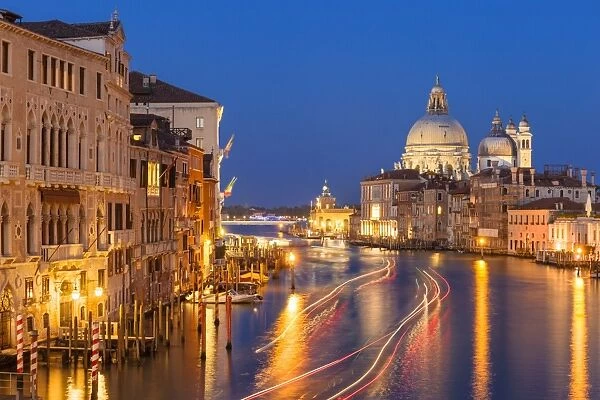 Grand Canal, and the church of Santa Maria della Salute, at night, with boat light trails