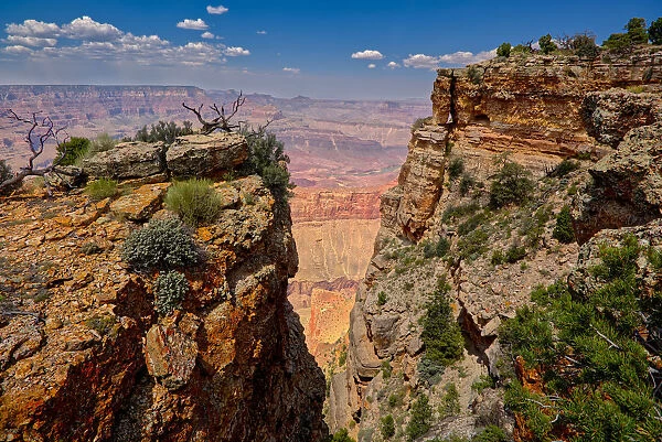 Grand Canyon view between two cliffs with a rock window on the right, located just