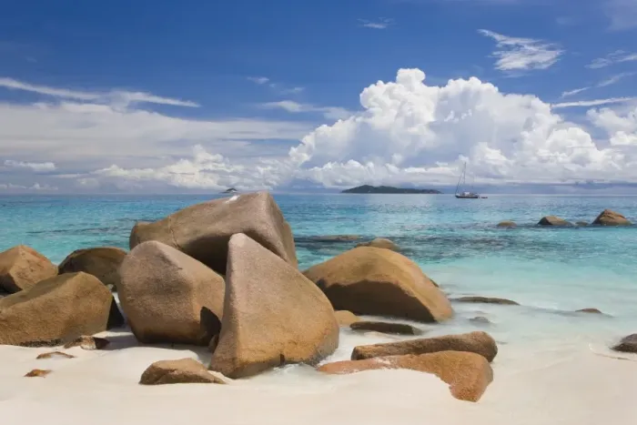 Framed Print : Granite boulders on the shore at Anse Lazio, island of Aride visible on horizon Framed Print : Granite boulders on the shore at Anse Lazio, island of Aride visible on horizon