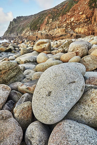 Granite boulders strewn across the shore at Porth Nanven, at the end of Cot Valley, near St. Just, Atlantic coast of the far west of Cornwall, England, United Kingdom, Europe