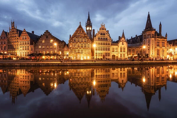 Graslei in the historic city of Ghent reflected in Leie river during blue hour, Ghent