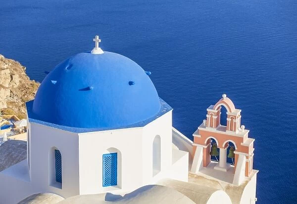 Greek church with blue dome and pink bell tower, Oia, Santorini (Thira), Cyclades Islands, Greek Islands, Greece, Europe