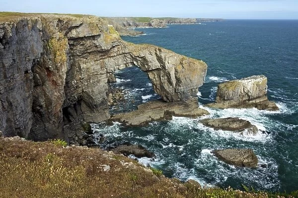 Green Bridge of Wales, natural rock arch, spring evening sunshine, Pembrokeshire Coast National Park, Wales, United