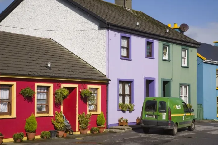 Framed Print : Green post van outside colourful houses in main street Framed Print : Green post van outside colourful houses in main street