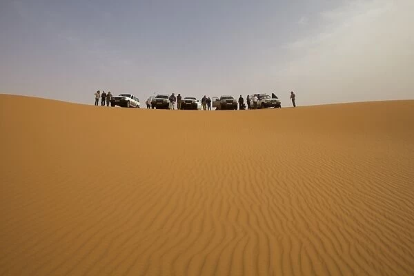A group of 4x4 vehicles in the dunes of the erg of Murzuk in the Fezzan desert