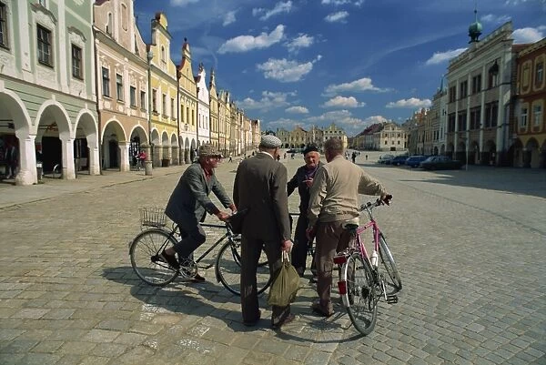 A group of elderly men talking in the 16th century town square in Telc