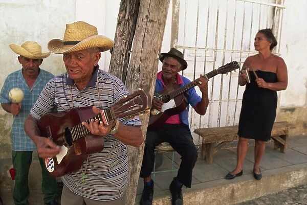 Group of three elderly men and a woman playing music, Trinidad, Cuba, West Indies