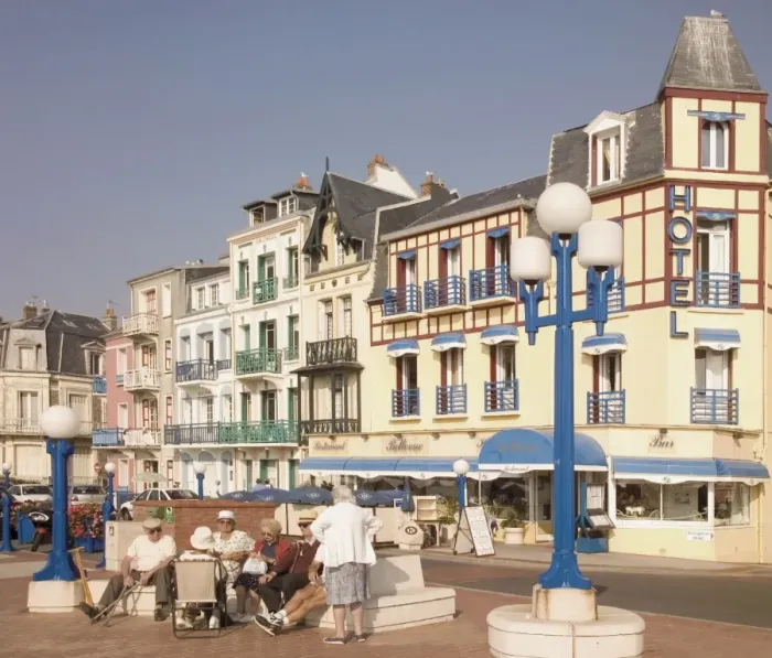 Framed Print : Group of elderly people sitting on seafront in the restort town of Mers les Bains Framed Print : Group of elderly people sitting on seafront in the restort town of Mers les Bains