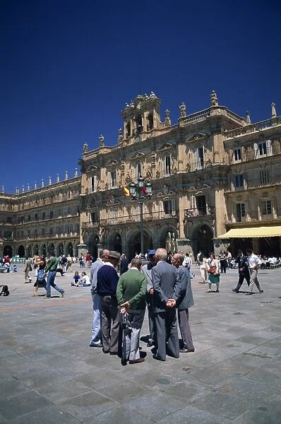 A group of men talking in front of the town hall in the Plaza Mayor