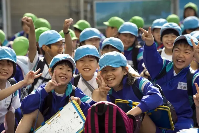 Framed Print : Group of smiling Japanese elementary school children wearing blue and green caps Framed Print : Group of smiling Japanese elementary school children wearing blue and green caps