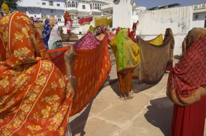 Framed Print : Group of women drying their saris by the sacred lake Framed Print : Group of women drying their saris by the sacred lake