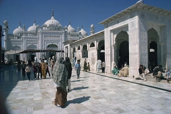 Groups of people at the Data Durbar Shrine in Lahore