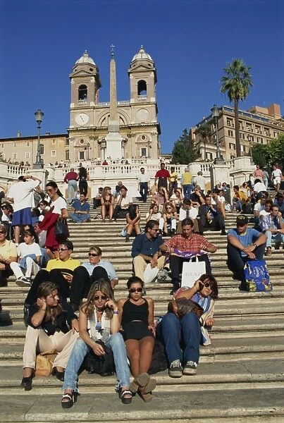 Groups of tourists sitting on the Spanish Steps with