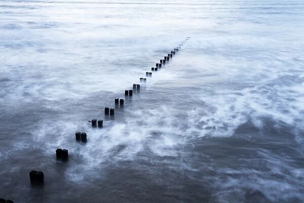 Groynes and incoming tide at Bridlington, East Riding of Yorkshire, England, United Kingdom, Europe