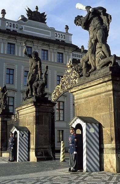 Two guards in front of the gate to Prague Castle, which has a titan statue on each of its two pillars, Hradcany, Prague, Czech