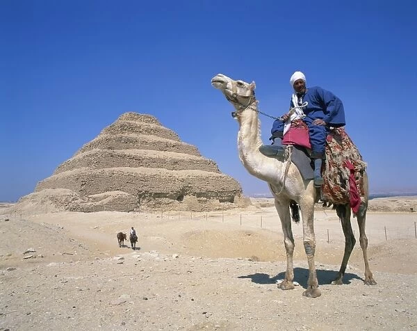 Guide on camel in front of the Step Pyramid of the pharaoh Zoser at Saqqara (Sakkara)