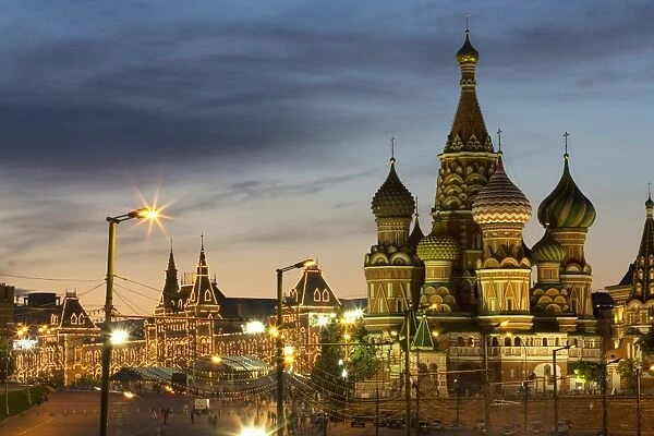 Gum department store and the onion domes of St. Basils Cathedral in Red Square illuminated at night, UNESCO World Heritage Site, Moscow, Russia, Europe