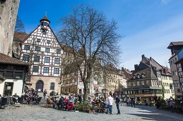 Half timbered houses and open air cafes on Albrecht Duerer square in the medieval